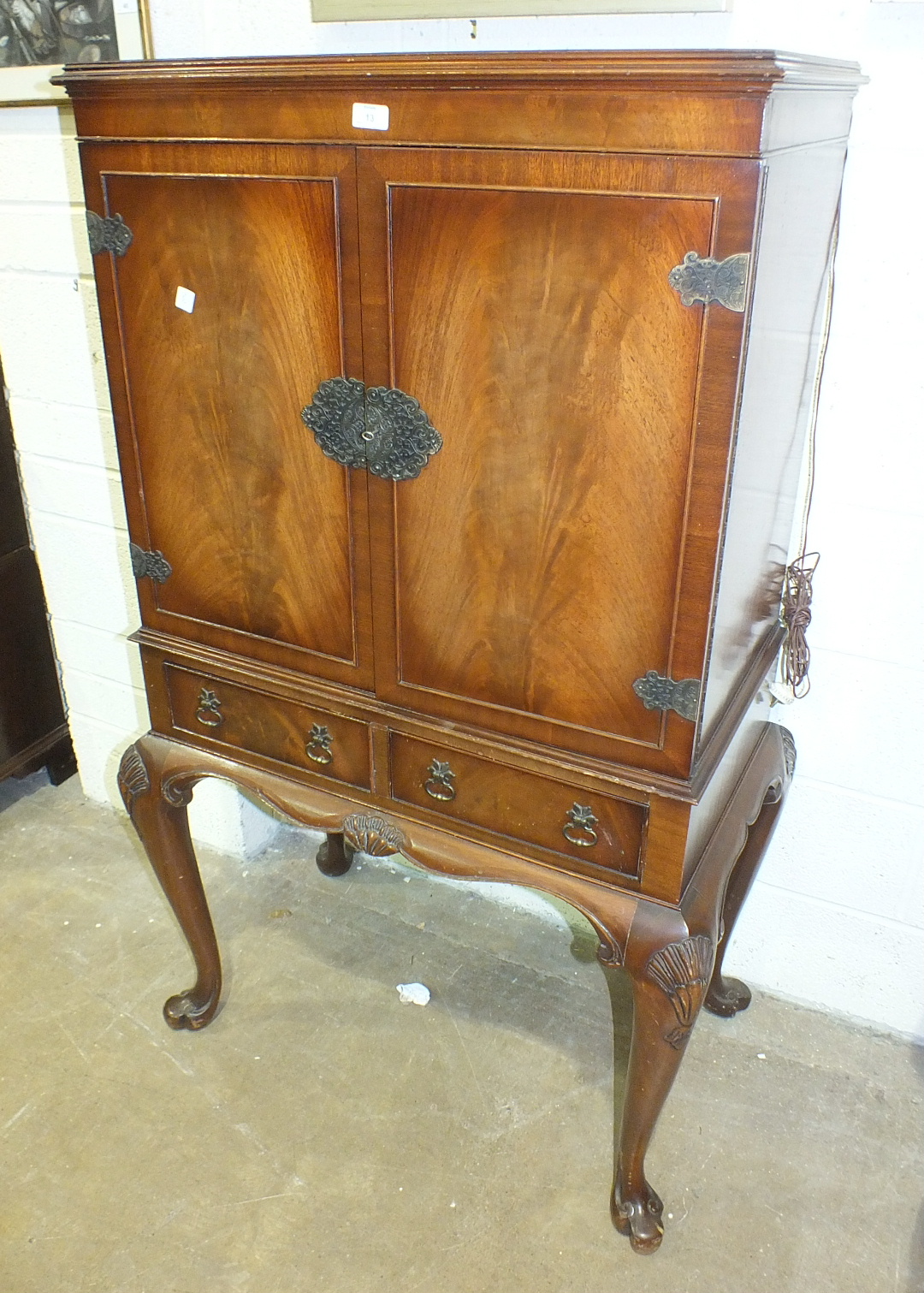 A walnut drinks cabinet with fitted interior, on cabriole legs and a mahogany side cabinet, (2).