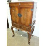 A walnut drinks cabinet with fitted interior, on cabriole legs and a mahogany side cabinet, (2).