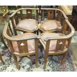 A set of four Edwardian oak corner chairs with low bowed backs, pierced Art Nouveau-style floral