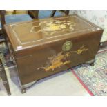 A mid-20th century camphor wood chest with carved sides and lid depicting vases of flowers, 100cm