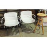 A pair of chrome-framed armchairs with white Rexine seats and backs, (some damage to seats) and an
