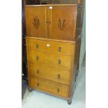 A 1920's/30's oak tallboy having a pair of doors with Art Deco inlaid decoration above four drawers,