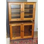 A pair of modern pine low bookcases fitted with a pair of glazed doors, 95cm wide, 74cm high, (2).