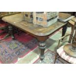 A late-19th century stained mahogany extending dining table on carved legs, includes two leaves, 257