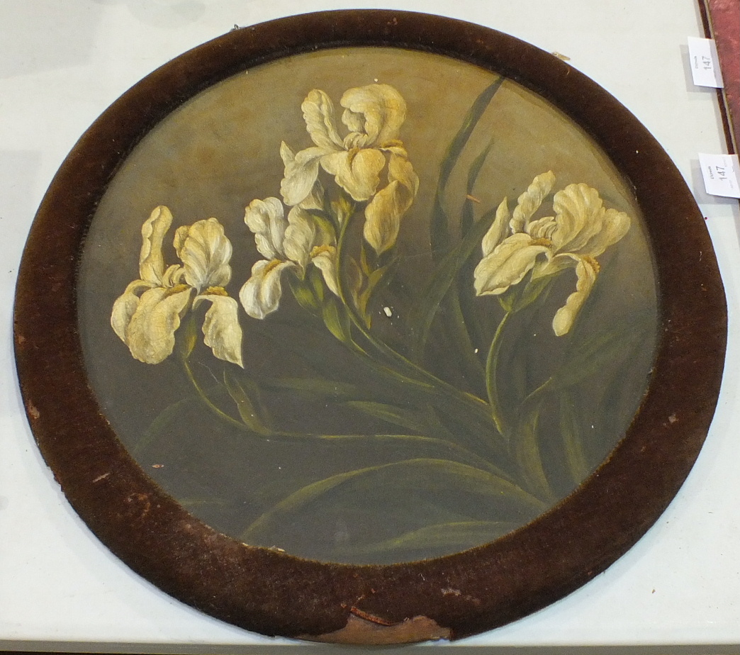 A large terracotta plate painted with yellow Irises, 40cm diameter, in circular velvet-covered