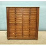 A late-19th century hardwood collector's cabinet, the rectangular top above two columns of fifteen