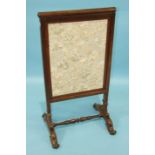 An early-19th century rosewood fire screen, the lift-up screen with later fabric covering, 50cm
