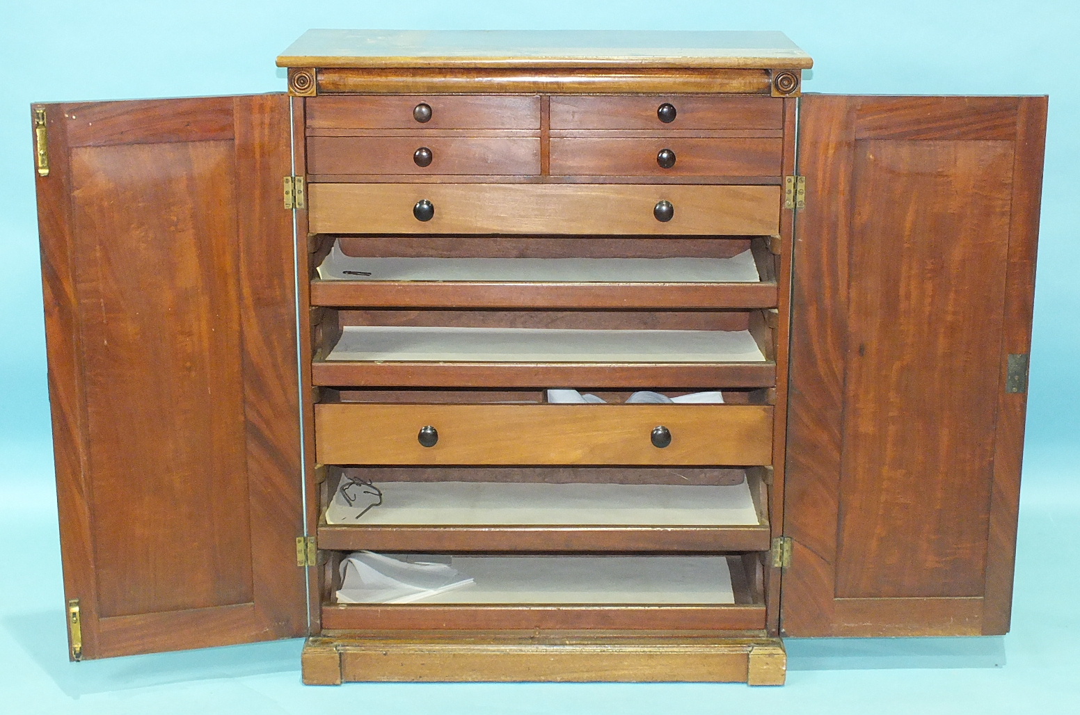 An early-19th century mahogany side cabinet of rectangular shape having a pair of panelled doors