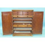 An early-19th century mahogany side cabinet of rectangular shape having a pair of panelled doors