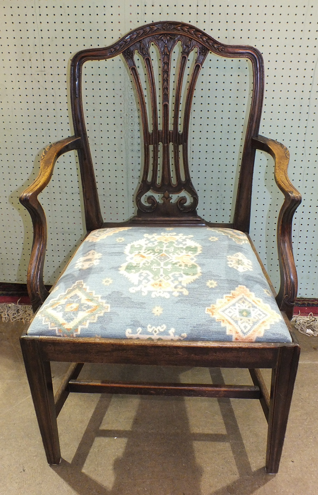 A set of eight Hepplewhite-style mahogany dining chairs, the arched pierced splat back with carved