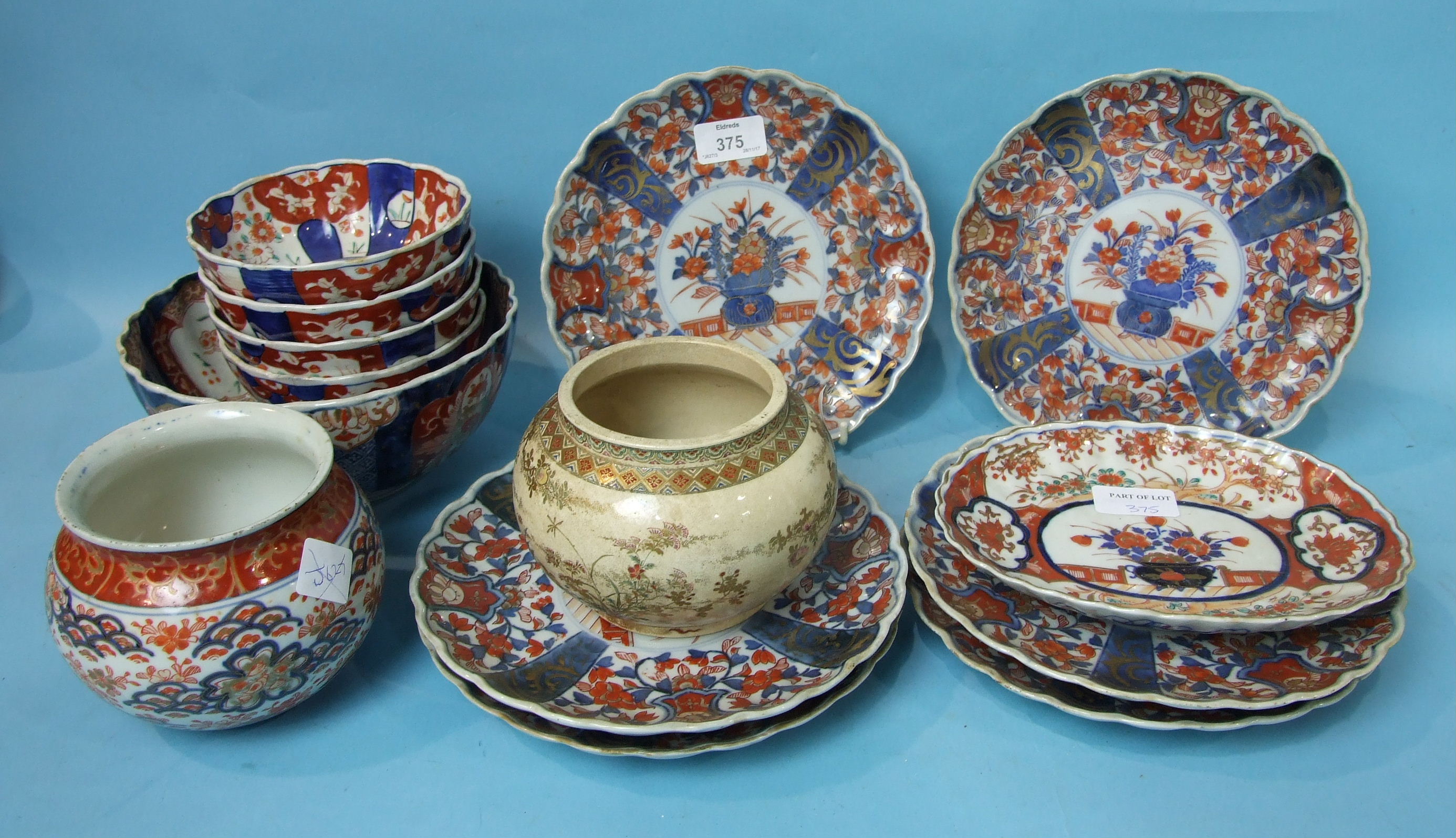 A set of six Japanese Imari shaped-rim plates, 21cm diameter, a similar oval dish, six similar bowls