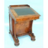 A Victorian walnut Davenport writing desk, the lift lid with maple interior fitted with drawers
