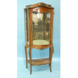 A 19th century kingwood vitrine in the Louis XV taste, with serpentine glazed door and side panels