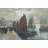 Henri Alphonse Barnoin (1882-1940) FISHING BOATS IN A BRETON HARBOUR WITH NUMEROUS FIGURES ON THE