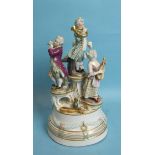 A 19th century Vienna porcelain group of four child musicians, on a circular plinth base, beehive