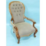 A Victorian carved walnut salon chair with button spoon-back, partially-upholstered arms and