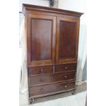 A Victorian mahogany linen press, the moulded cornice above a pair of panelled doors enclosing