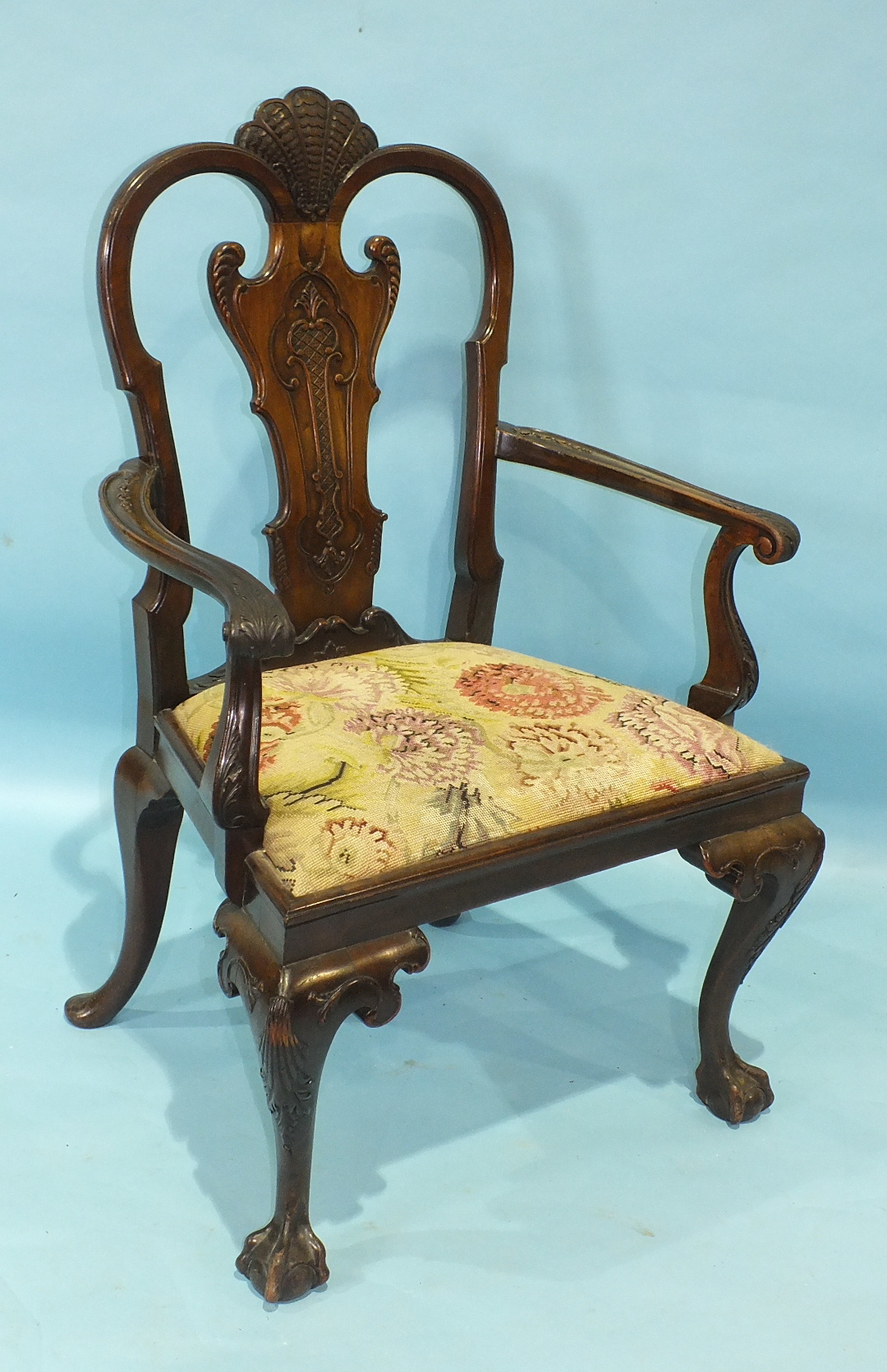 A large Chippendale-style mahogany armchair, the carved vase splat surmounted by shell carving,