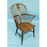 An elm and beech Windsor armchair, the shaped solid seat on turned legs with H-stretcher.