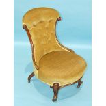 A Victorian upholstered button-back nursing chair with moulded frame and circular seat, on short