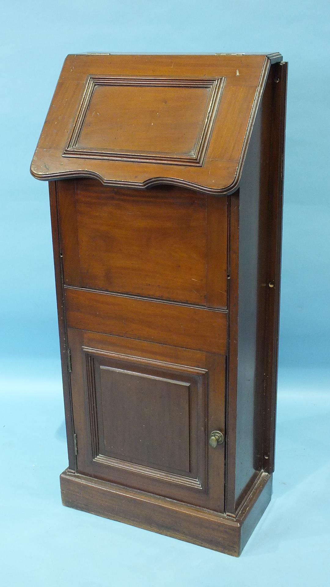 An unusual walnut marine bulkhead fold-away wash stand, the rising lid fitted with a mirror and