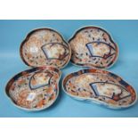 A set of four Japanese Imari shaped triangular dishes, 24.5cm long.