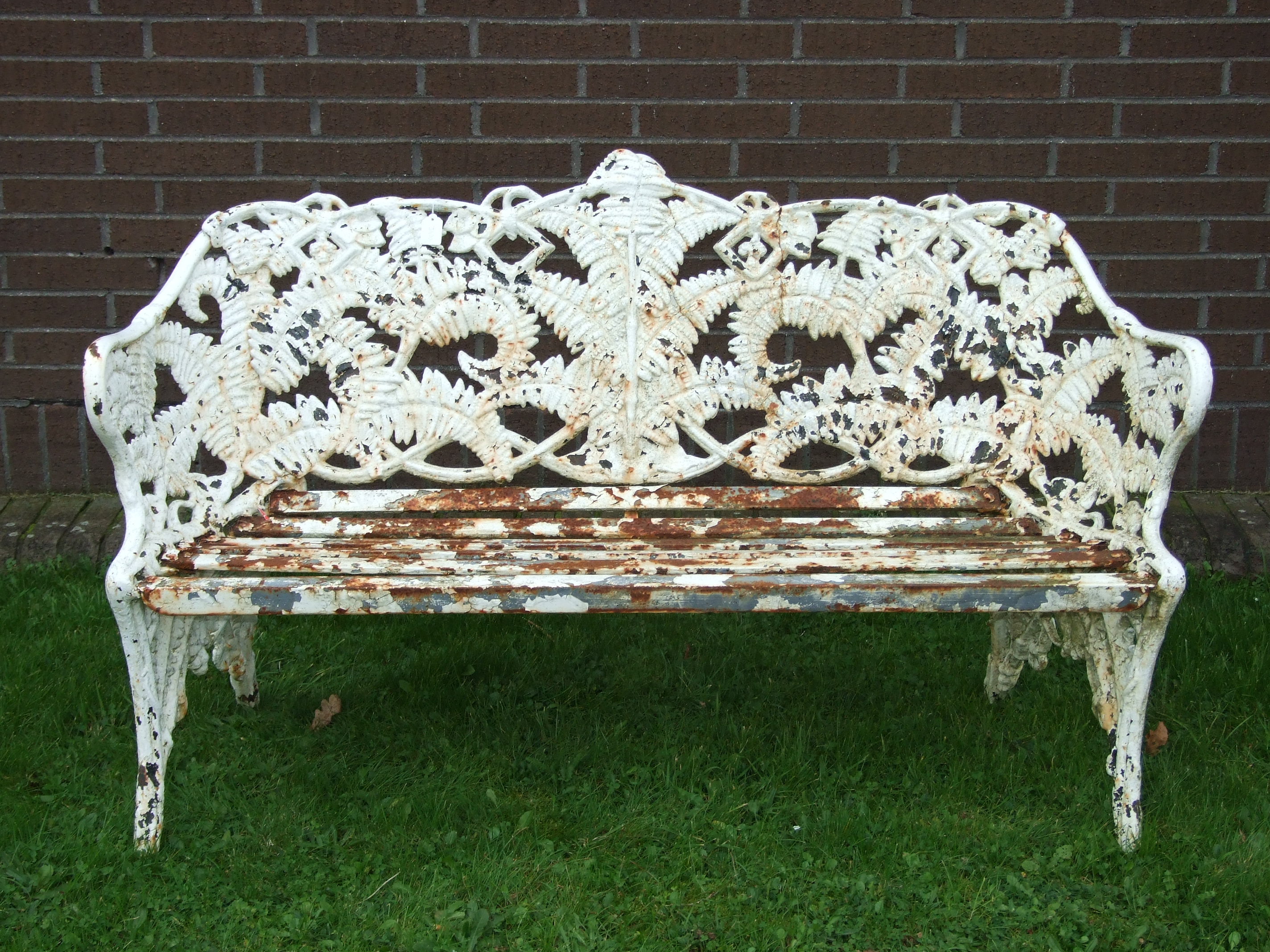 A cast iron fern pattern garden bench, 151cm wide, (old repairs to back).