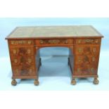 A mahogany reconstructed knee-hole desk, the rectangular top with inset writing surface above an