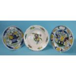 Three 18th/19th century Dutch Delft plates painted with flowers, (3).