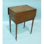 An early-19th century rosewood two-drawer work table, on turned legs with castors, (in need of