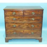 A George III mahogany rectangular chest of two short and three long cockbeaded drawers, on bracket