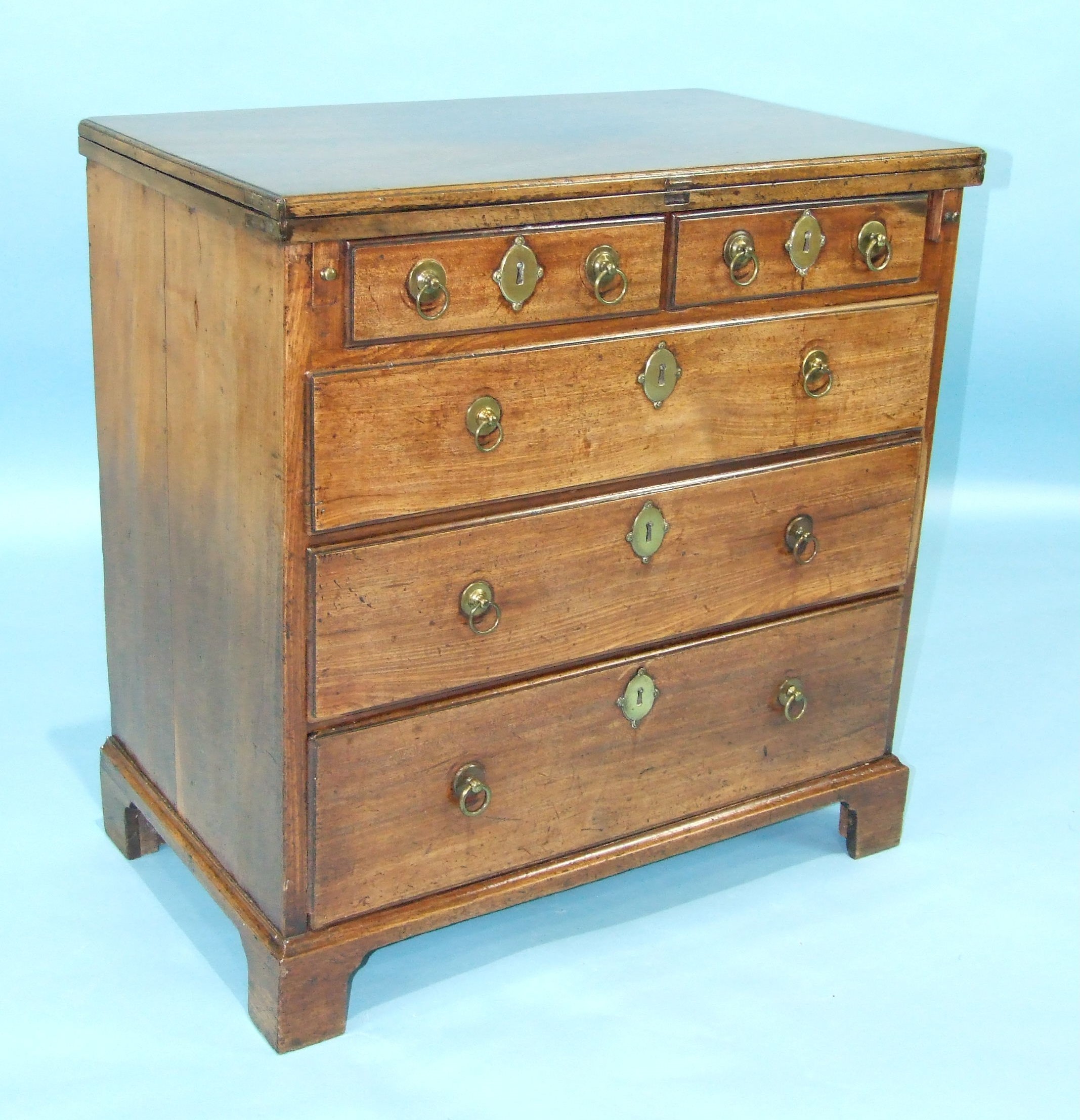 A Georgian mahogany bachelor's chest, the fold-over top above two short and three long moulded