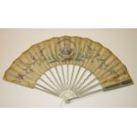 An 18th century fan, the guards pierced and overlaid with gold and silver, the sticks inlaid with