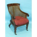 A good quality William IV rosewood Bergère chair, the frame carved with foliate detail and scroll