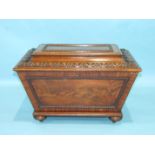 A Victorian mahogany wine cooler of sarcophagus shape with carved mouldings, on bun feet, 73cm wide,