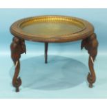 An early-20th century Indian carved hardwood circular table, the removable brass tray within