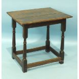 An antique oak occasional table, the rectangular top on turned supports joined by stretchers, 63 x