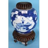 A 19th century Chinese porcelain ovoid jar decorated with panels of antique objects on a prunus