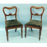 A set of eight Victorian rosewood balloon-back dining chairs with drop-in seats, on turned and