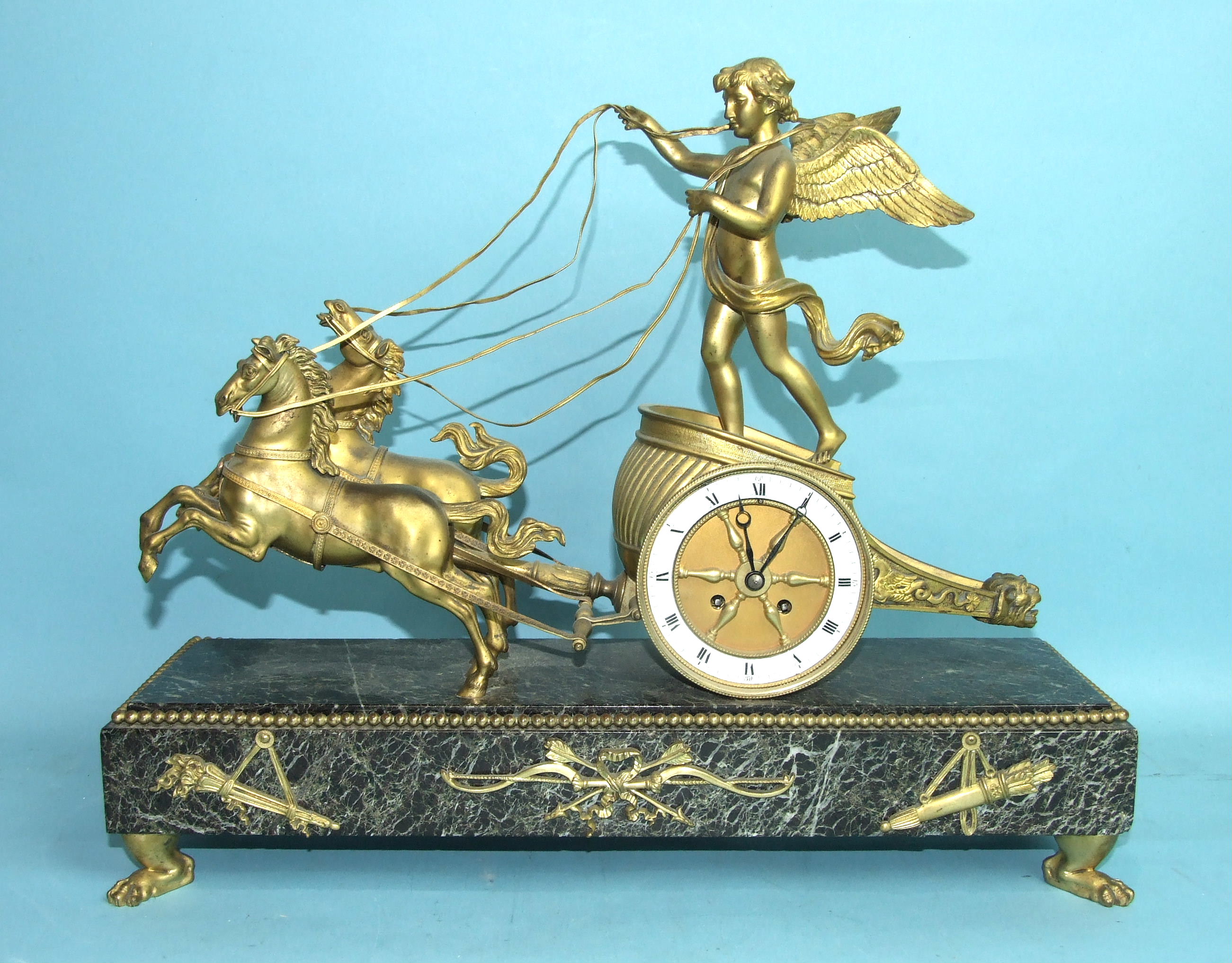 A 19th century French ormolu and marble mantel clock in the form of a chariot driven by a cherub and