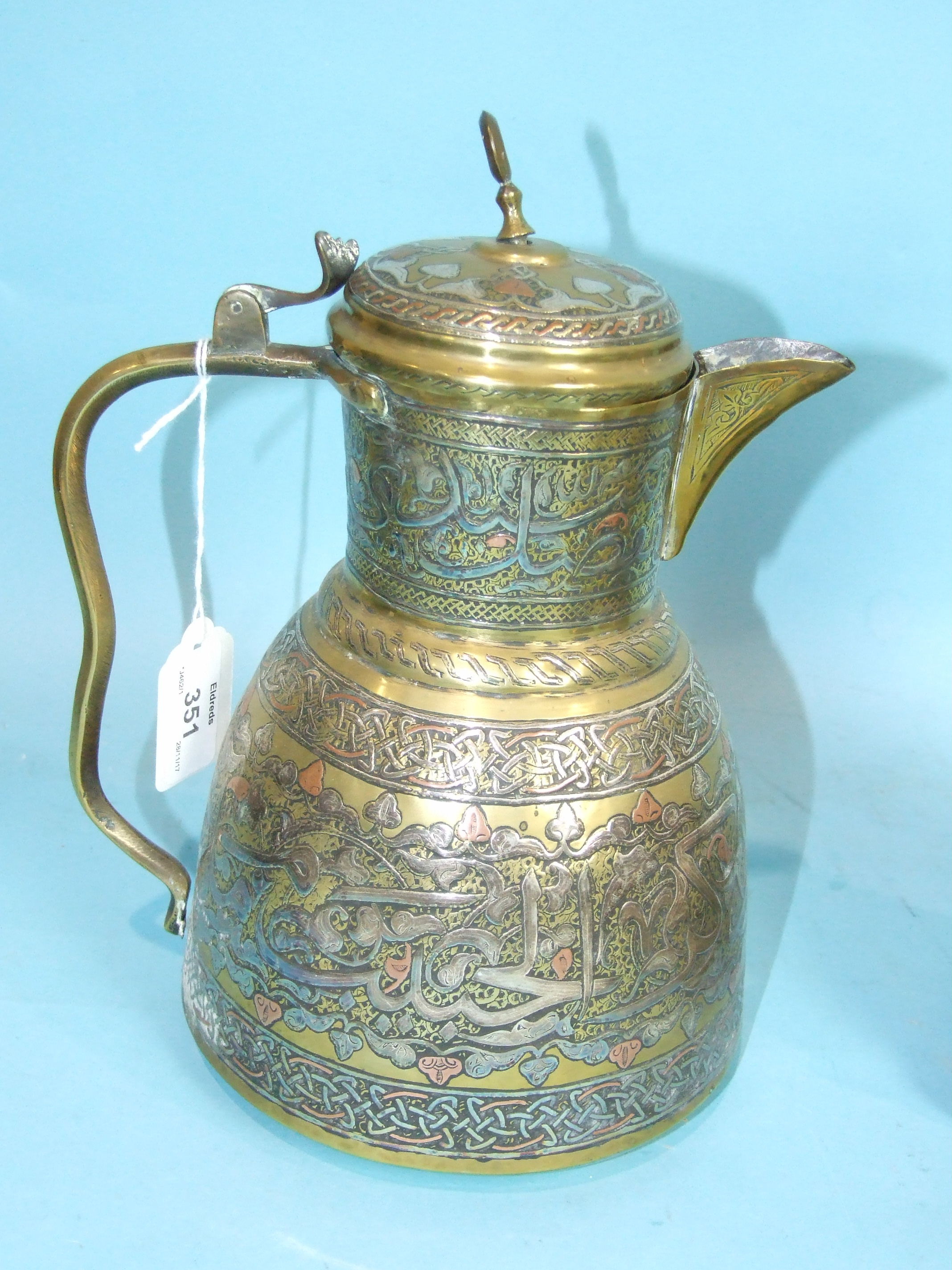 A Middle Eastern brass ewer inlaid with silver and copper, two similar smaller pieces and a stone - Image 2 of 4