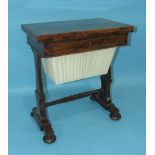 A Victorian rosewood work table, the baize-lined fold-over top above a fitted drawer, work basket on