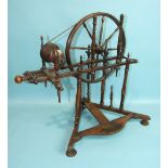 A late-19th century stained turned wood spinning wheel, 60cm high, 60cm wide.
