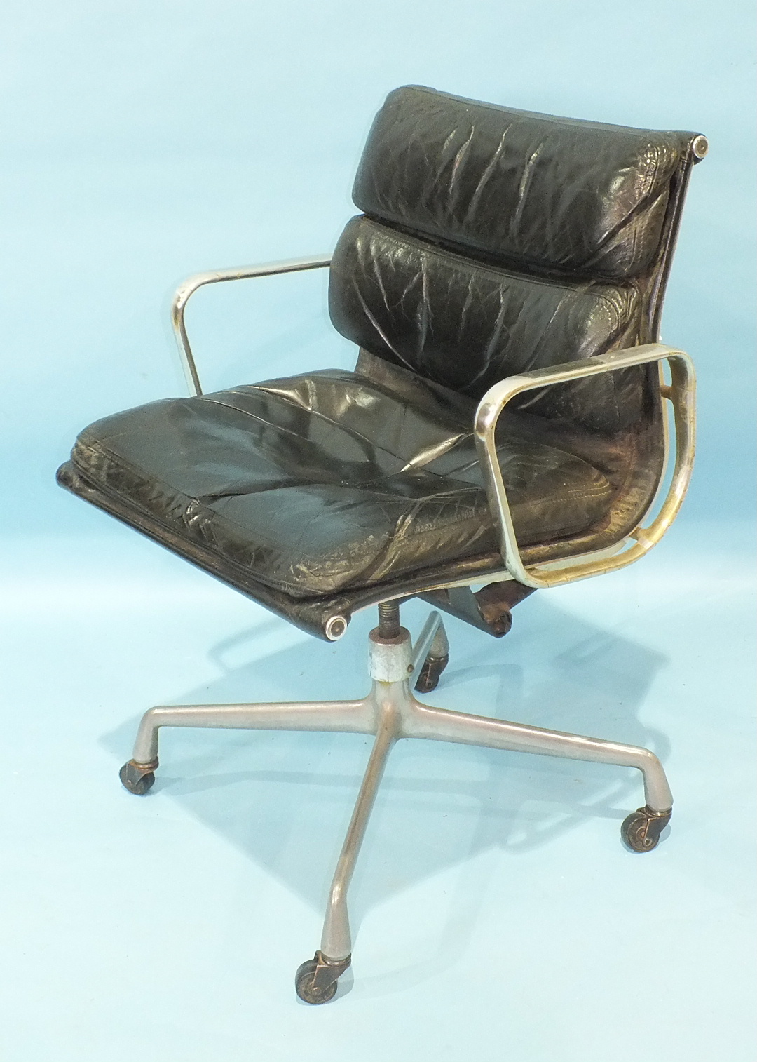 An Eames-style soft pad revolving office chair, (in poor condition).
