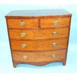 A Late-Georgian figured mahogany bow-fronted chest of two short and three long cockbeaded drawers,