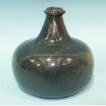 A rare early English small wine bottle of onion form in an unusual tint of blue/green colour, c1700,