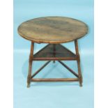 An 18th/19th century elm cricket table, the circular top on triangular stretchered base with