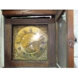 A late-18th/early-19th century oak long case clock, the 11'' brass dial with calendar subsidiary,