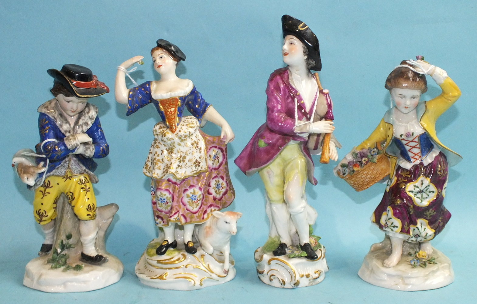 Four Continental porcelain figures engaged in rural pursuits.