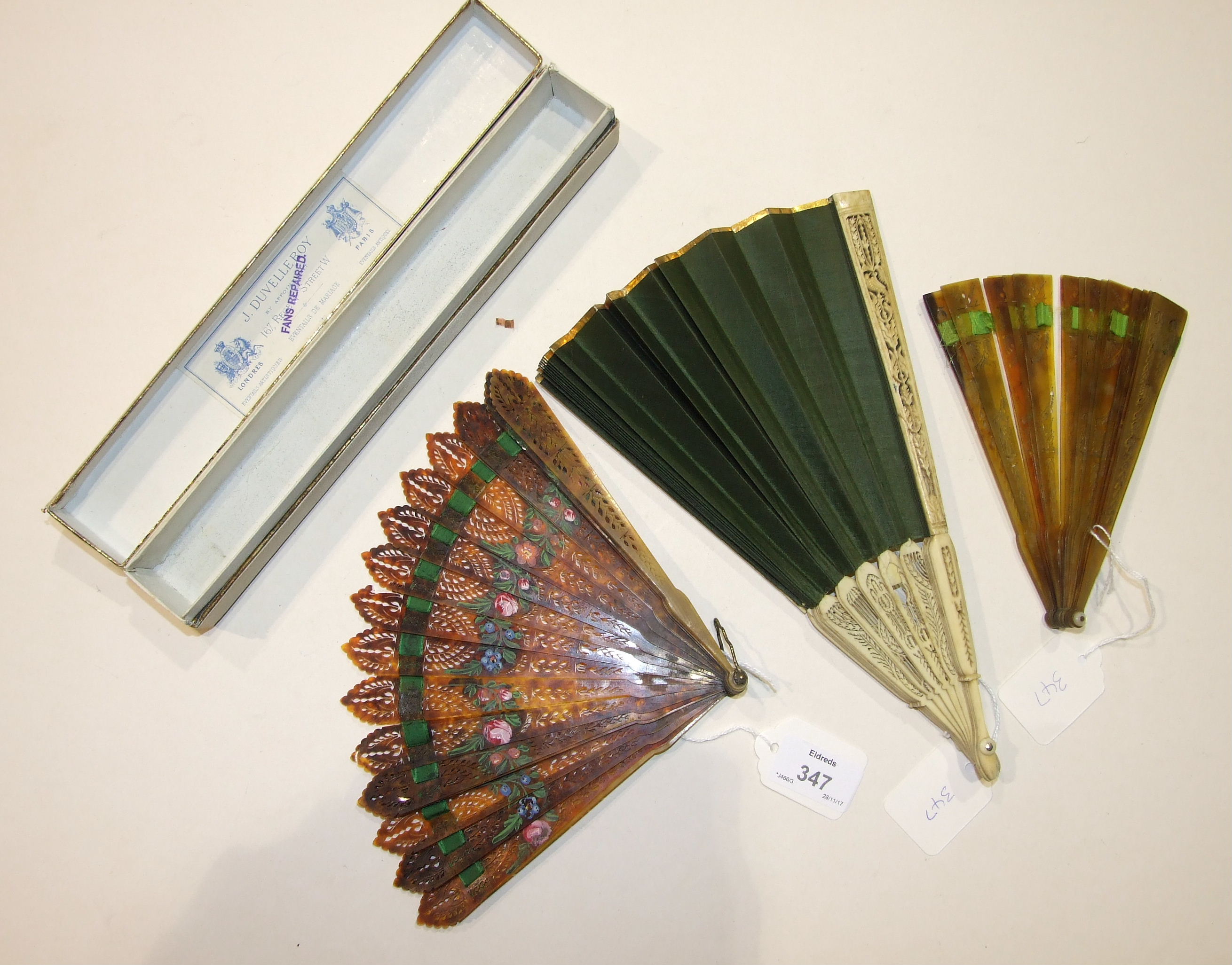 An 18th century fan with pierced and carved bone guards and sticks and green silk leaf, (a/f),